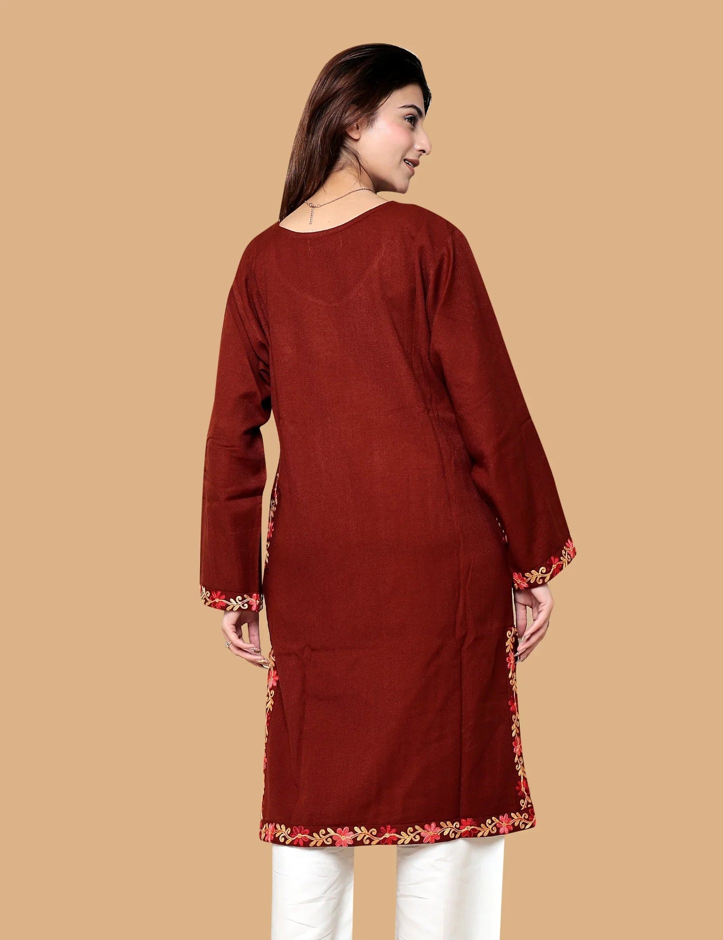 Woman wearing red Kashmiri phiran with hand embroidery
