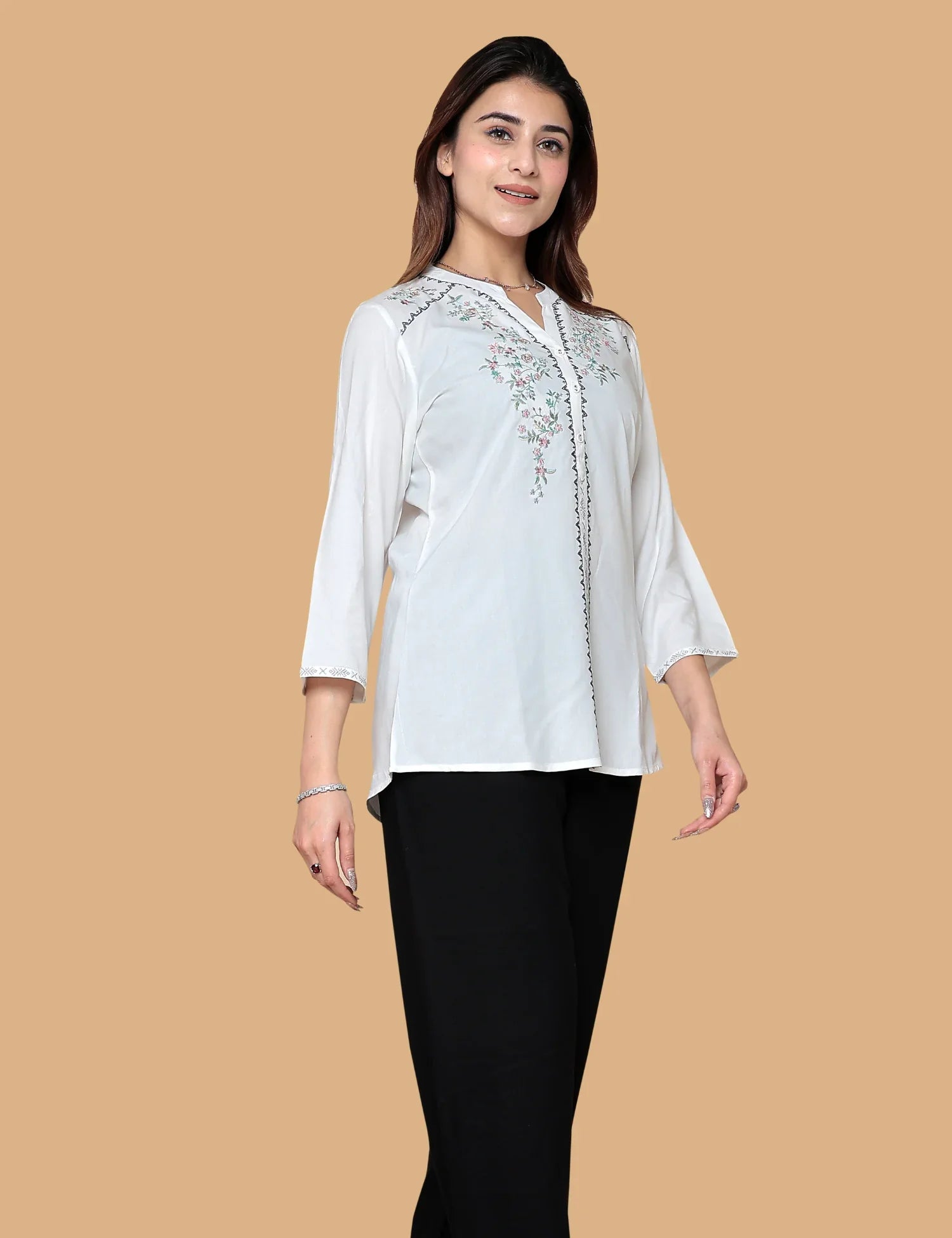 Woman wearing white embroidered short kurti